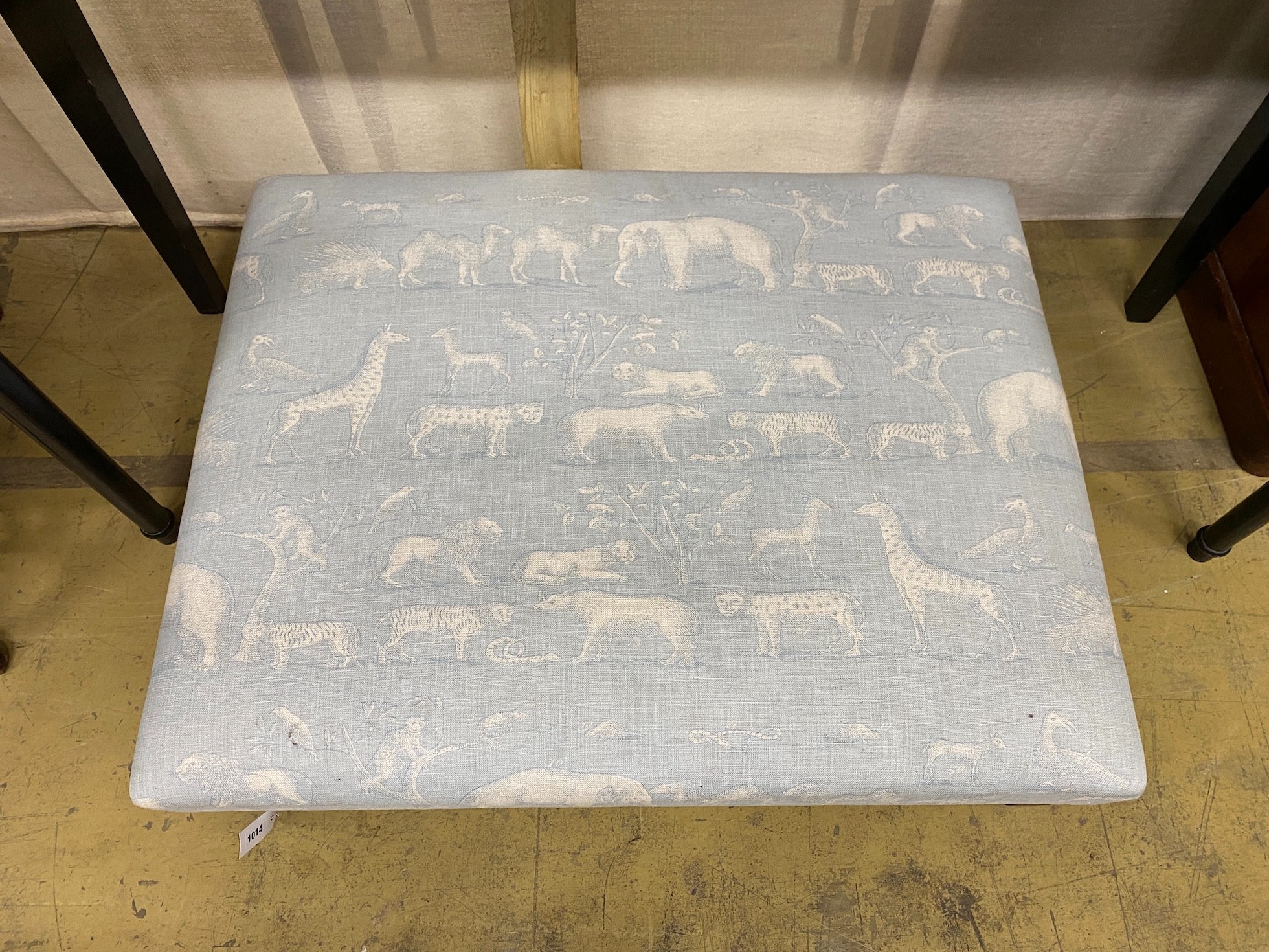 A contemporary rectangular footstool upholstered in Andrew Martin animal print fabric, width 103cm, height 80cm